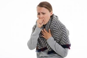 What happens if an employee has to self-isolate? - Woman coughing